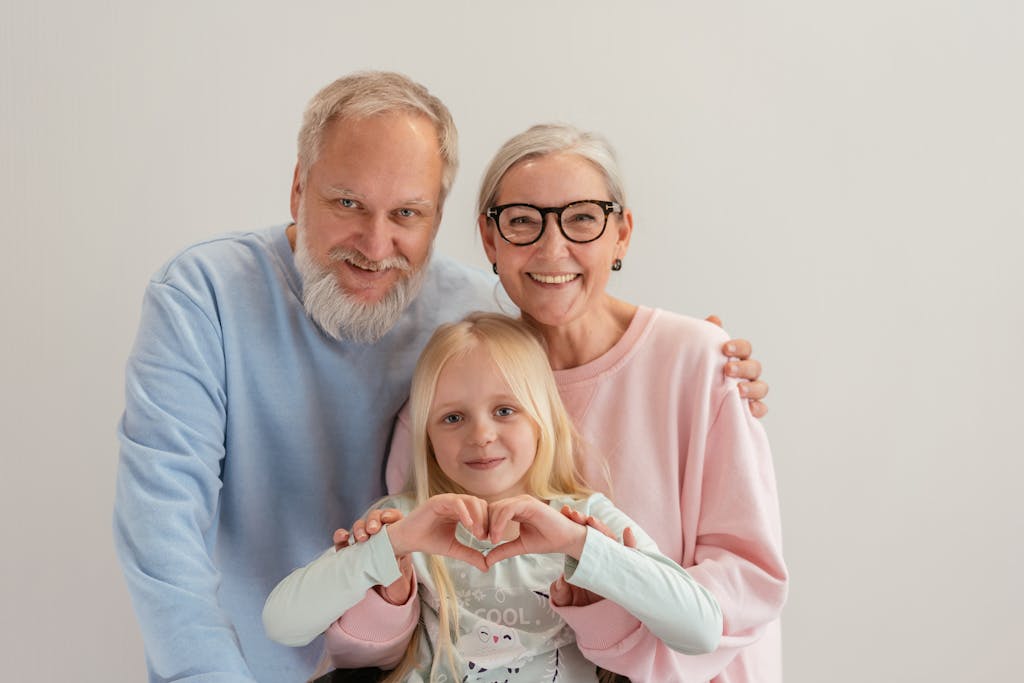 Grandparents and granddaughter share a joyful moment, symbolizing love and family unity indoors.